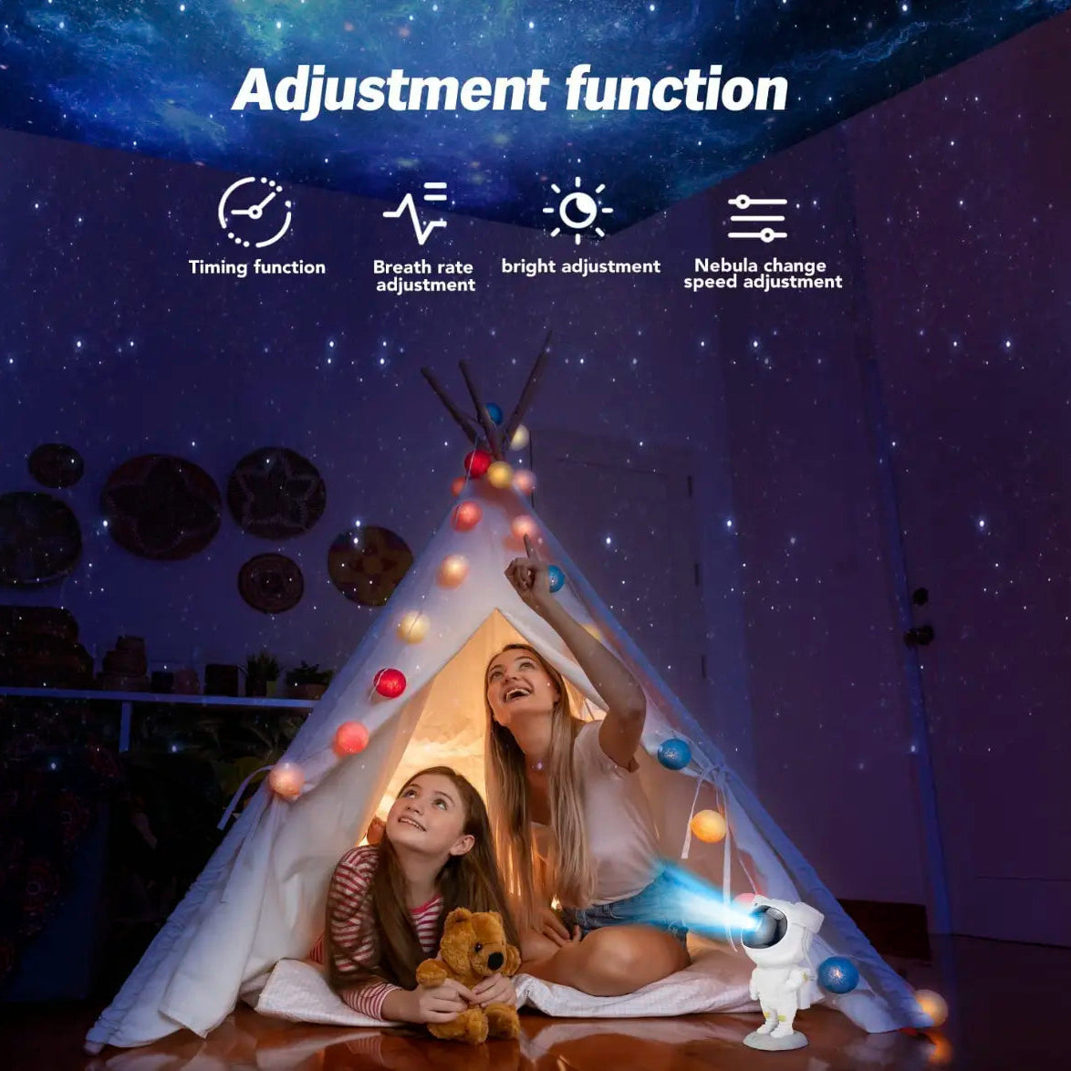 Astronaut-shaped night light projector projecting colorful lights on a ceiling, with a hand holding a remote control.